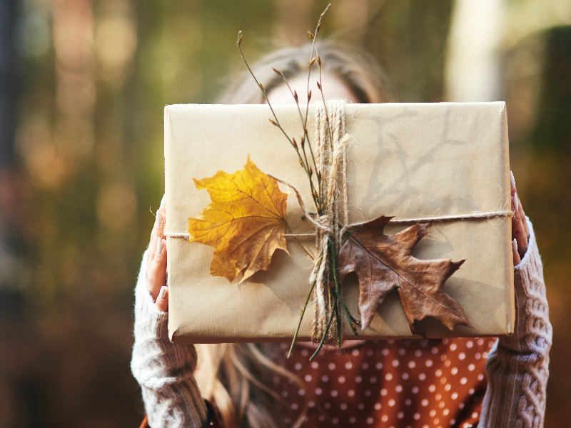 close-up-woman-s-hands-holding-gift-autumn-forest.jpg