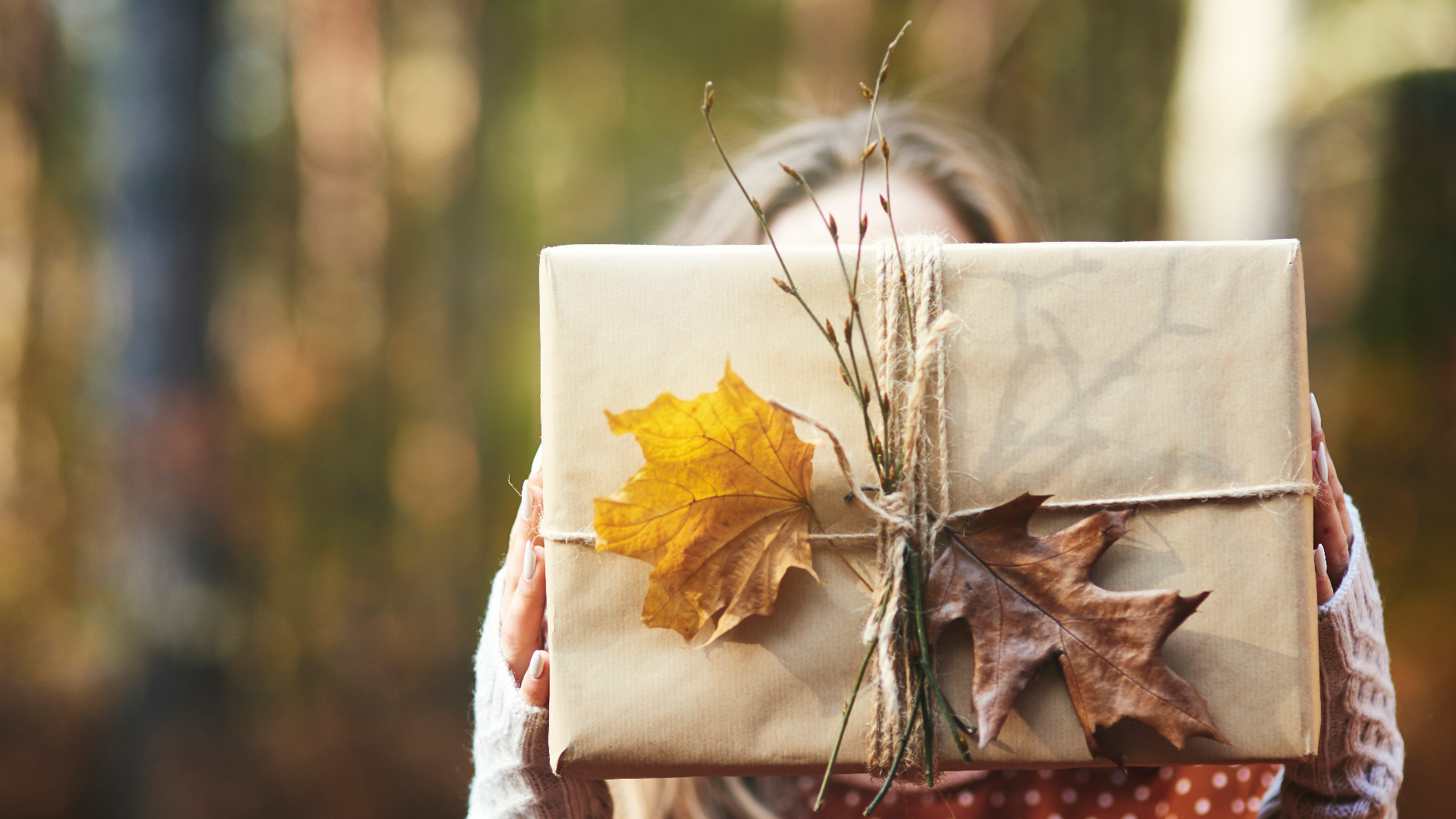 close-up-woman-s-hands-holding-gift-autumn-forest.jpg